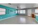 Bright living room with tile floors, neutral paint, ceiling fan, and abundant natural light at 9476 Milkweed Canyon Ave, Las Vegas, NV 89166