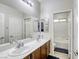 Bathroom featuring double sinks, modern fixtures, and a separate shower/tub at 9535 Vega Carpio Ave, Las Vegas, NV 89178