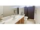 Bathroom featuring a white countertop, dark wood cabinets, and a white toilet at 9535 Vega Carpio Ave, Las Vegas, NV 89178