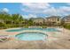 Resort-style community pool and hot tub surrounded by lounge chairs for relaxing and socializing at 9535 Vega Carpio Ave, Las Vegas, NV 89178