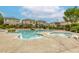 Large community pool and jacuzzi offer ample space for relaxation and recreation with nearby seating at 9535 Vega Carpio Ave, Las Vegas, NV 89178