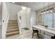 Spacious dining area adjacent to the stairs, showcasing modern decor and an open layout at 9535 Vega Carpio Ave, Las Vegas, NV 89178