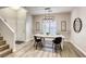 Bright dining area features modern light fixture and stylish décor that complements the flooring at 9535 Vega Carpio Ave, Las Vegas, NV 89178