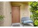 Close-up of the front door, with a bench and welcome mat, creating a cozy entrance at 9535 Vega Carpio Ave, Las Vegas, NV 89178