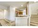 Bright kitchen with stainless steel appliances, wood cabinets, and an adjacent staircase at 9535 Vega Carpio Ave, Las Vegas, NV 89178