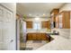 Well-lit kitchen features wood cabinets, stainless steel appliances, and marble countertops at 9535 Vega Carpio Ave, Las Vegas, NV 89178