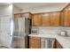 Kitchen featuring stainless steel appliances, wood cabinets, and marble countertops at 9535 Vega Carpio Ave, Las Vegas, NV 89178