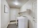 Bright laundry room with modern washer and dryer, storage shelf, and neutral walls at 9535 Vega Carpio Ave, Las Vegas, NV 89178
