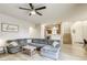 Open-concept living room with large sectional, view to the kitchen and dining areas, and modern design at 9535 Vega Carpio Ave, Las Vegas, NV 89178