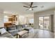 Spacious living area with a large sectional sofa, open layout, and flow to kitchen and dining areas at 9535 Vega Carpio Ave, Las Vegas, NV 89178