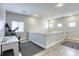 Bright open loft featuring neutral walls and flooring, lots of natural light, and views of the stairs at 9535 Vega Carpio Ave, Las Vegas, NV 89178