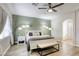 Spacious main bedroom features a ceiling fan, ensuite bath, and a decorative accent wall at 9535 Vega Carpio Ave, Las Vegas, NV 89178