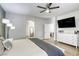 Spacious main bedroom features a ceiling fan, ensuite bath, and a decorative accent wall at 9535 Vega Carpio Ave, Las Vegas, NV 89178