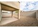 View of the backyard with a covered patio area and low-maintenance gravel landscaping at 9750 Maple Sugar Leaf Pl, Las Vegas, NV 89148