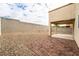 The backyard has a brick patio and gravel landscaping, enclosed by a tall block wall for privacy at 9750 Maple Sugar Leaf Pl, Las Vegas, NV 89148