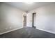 A bright bedroom featuring soft carpet, neutral walls, closet, and an open doorway to another room at 9750 Maple Sugar Leaf Pl, Las Vegas, NV 89148