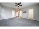 Carpeted bedroom with neutral paint and a ceiling fan, offering ample space and natural light at 9750 Maple Sugar Leaf Pl, Las Vegas, NV 89148
