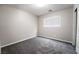 A cozy bedroom offers neutral paint, carpet, a window for natural light, and ample electrical outlets at 9750 Maple Sugar Leaf Pl, Las Vegas, NV 89148