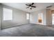 Bedroom featuring carpeted floors, neutral paint, windows, and access to a bathroom at 9750 Maple Sugar Leaf Pl, Las Vegas, NV 89148