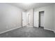 This calm bedroom has soft carpet, neutral walls, a closet with a sliding door, and an open doorway at 9750 Maple Sugar Leaf Pl, Las Vegas, NV 89148