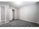 This calm bedroom features soft carpet, neutral walls, a closet with a sliding door, and an open doorway at 9750 Maple Sugar Leaf Pl, Las Vegas, NV 89148