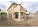 Rear exterior of the home showing the patio, balcony, and low-maintenance gravel yard at 9750 Maple Sugar Leaf Pl, Las Vegas, NV 89148