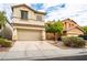 Attractive two-story home with a two-car garage, desert landscaping, and a neutral-colored exterior at 9750 Maple Sugar Leaf Pl, Las Vegas, NV 89148