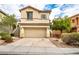 Charming two-story home featuring a two-car garage, desert landscaping, and neutral stucco exterior at 9750 Maple Sugar Leaf Pl, Las Vegas, NV 89148