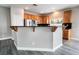 Kitchen featuring oak cabinets, stainless steel appliances, and black countertops with raised breakfast bar at 9750 Maple Sugar Leaf Pl, Las Vegas, NV 89148