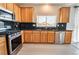 Bright kitchen featuring granite countertops, stainless steel appliances, and tile floors at 9750 Maple Sugar Leaf Pl, Las Vegas, NV 89148