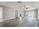 Open living room featuring wood laminate flooring, neutral paint, and access to the backyard at 9750 Maple Sugar Leaf Pl, Las Vegas, NV 89148