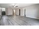 Spacious living room with wood laminate flooring, neutral paint, and open floor plan at 9750 Maple Sugar Leaf Pl, Las Vegas, NV 89148