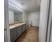 This bathroom features a double sink vanity with granite countertop and accessible grab bars by the toilet and shower at 9975 Peace Way # 1140, Las Vegas, NV 89147