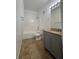 Bathroom with white tile tub/shower combo, gray vanity, quartz counters and tile floors at 9975 Peace Way # 1140, Las Vegas, NV 89147