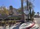 Chateau Nouveau community entrance with well-maintained landscaping and palm trees at 9975 Peace Way # 1140, Las Vegas, NV 89147