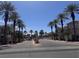 View of Chateau Nouveau's gated entrance lined with palm trees, leading to the community at 9975 Peace Way # 1140, Las Vegas, NV 89147