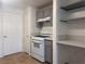 Kitchen boasts gray cabinets, white appliances, quartz countertops, tile floors, and bright lighting at 9975 Peace Way # 1140, Las Vegas, NV 89147