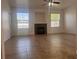 A spacious living room with a fireplace, neutral walls, tile floor, and bright light from two windows at 9975 Peace Way # 1140, Las Vegas, NV 89147