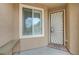 Inviting entryway with a decorative security door, window, tiled floor, and exterior bench seating at 10241 Premia Pl, Las Vegas, NV 89135