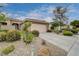 Charming single-story home featuring a two-car garage and desert landscaping with a tiled roof at 10241 Premia Pl, Las Vegas, NV 89135