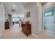 Bright foyer with a view into the bathroom, Gathering room, and living room featuring neutral paint and tile floors at 10241 Premia Pl, Las Vegas, NV 89135