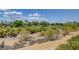 Elevated view of a sprawling golf course featuring undulating greens and native desert vegetation at 10241 Premia Pl, Las Vegas, NV 89135