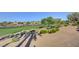 Beautiful golf course view with a pond, lush greenery, mature trees, and desert foliage at 10241 Premia Pl, Las Vegas, NV 89135