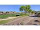 Scenic golf course view with a tranquil lake, manicured greens, and mature trees at 10241 Premia Pl, Las Vegas, NV 89135