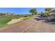 Beautiful golf course view featuring a sand trap, pond, and a tree-lined path at 10241 Premia Pl, Las Vegas, NV 89135