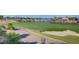 Scenic golf course with a pond, sand trap, and pathway; perfect for leisurely strolls at 10241 Premia Pl, Las Vegas, NV 89135