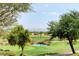 Scenic golf course with a tranquil pond, surrounded by manicured greens and a backdrop of distant mountains at 10241 Premia Pl, Las Vegas, NV 89135