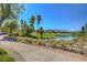 Beautiful view of a golf course lake and desert landscaping with mountains in the background at 10241 Premia Pl, Las Vegas, NV 89135