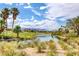 Picturesque view of golf course and lake with mountains in background on a sunny day at 10241 Premia Pl, Las Vegas, NV 89135