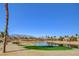 Beautiful view of a golf course lake surrounded by lush greenery and distant mountain views at 10241 Premia Pl, Las Vegas, NV 89135